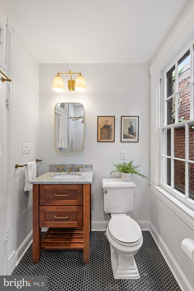 bathroom featuring toilet and vanity