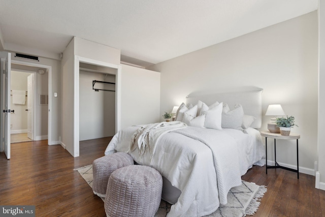 bedroom with dark hardwood / wood-style flooring