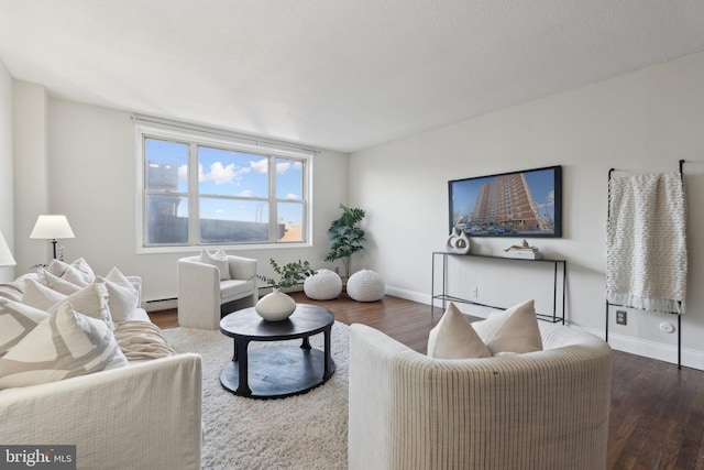 living room featuring dark hardwood / wood-style flooring and a baseboard heating unit