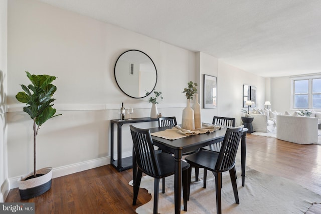 dining area with dark hardwood / wood-style flooring