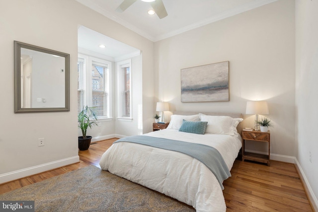 bedroom featuring ceiling fan, ornamental molding, and hardwood / wood-style floors