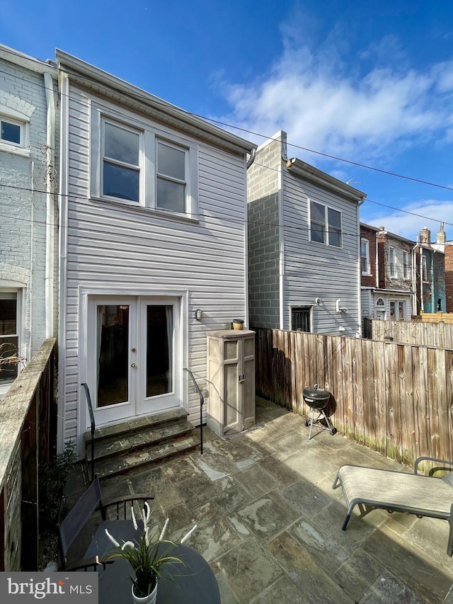 back of house featuring a patio area and french doors