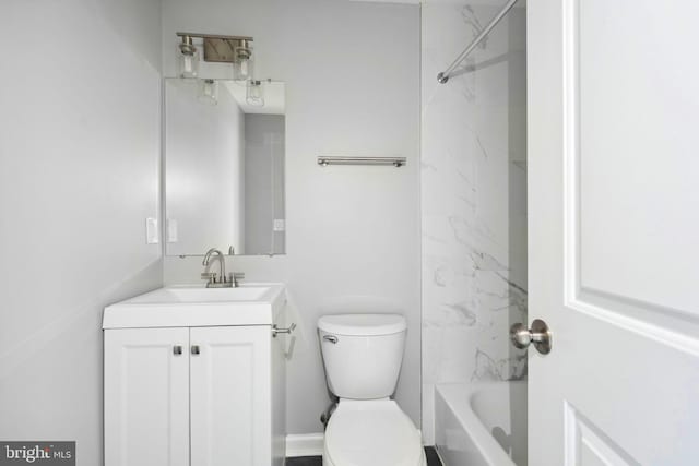 full bathroom with tiled shower / bath, vanity, and toilet