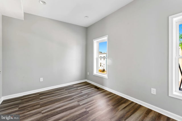 unfurnished room featuring dark hardwood / wood-style flooring