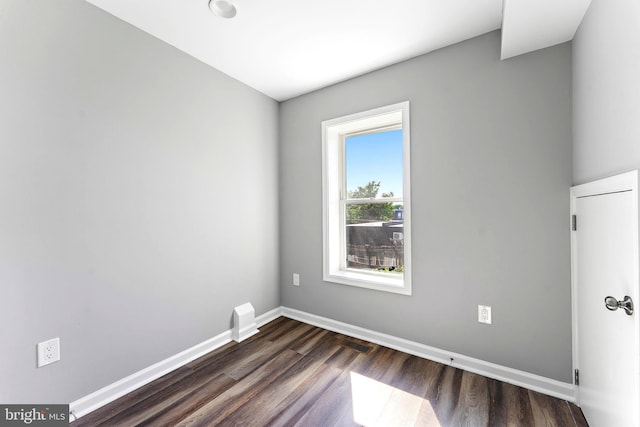 unfurnished room featuring dark hardwood / wood-style floors