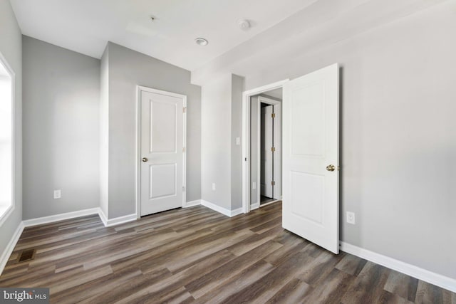 unfurnished bedroom featuring dark hardwood / wood-style floors