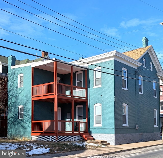 view of home's exterior featuring a porch and a balcony