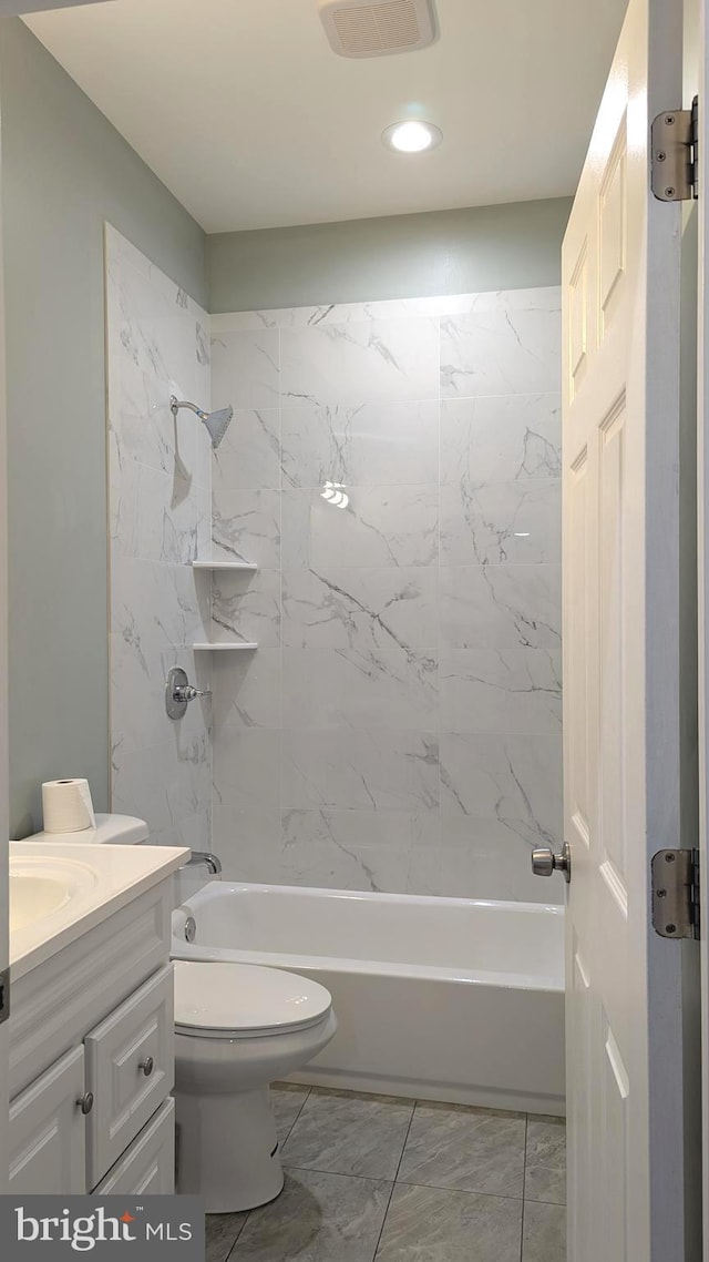 full bathroom featuring toilet, vanity, and tiled shower / bath