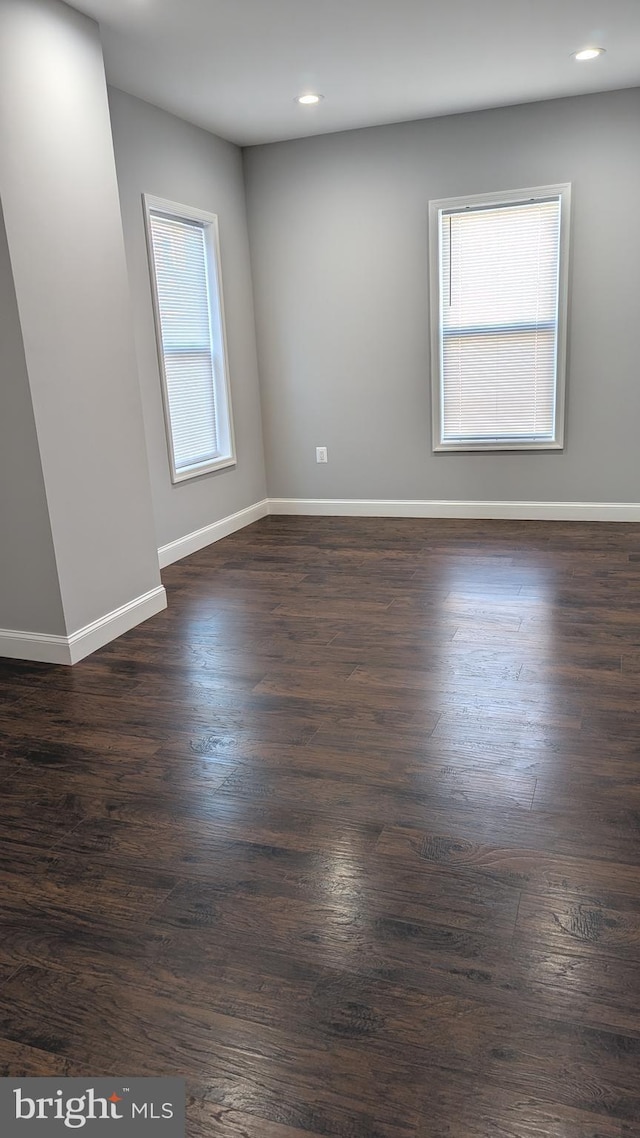 spare room featuring dark wood-type flooring