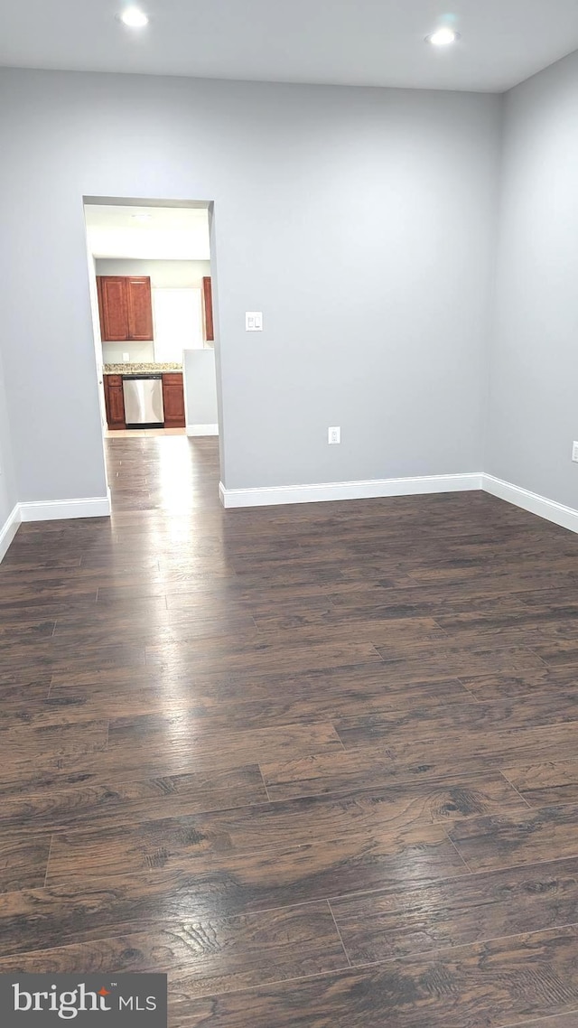 spare room with dark hardwood / wood-style floors