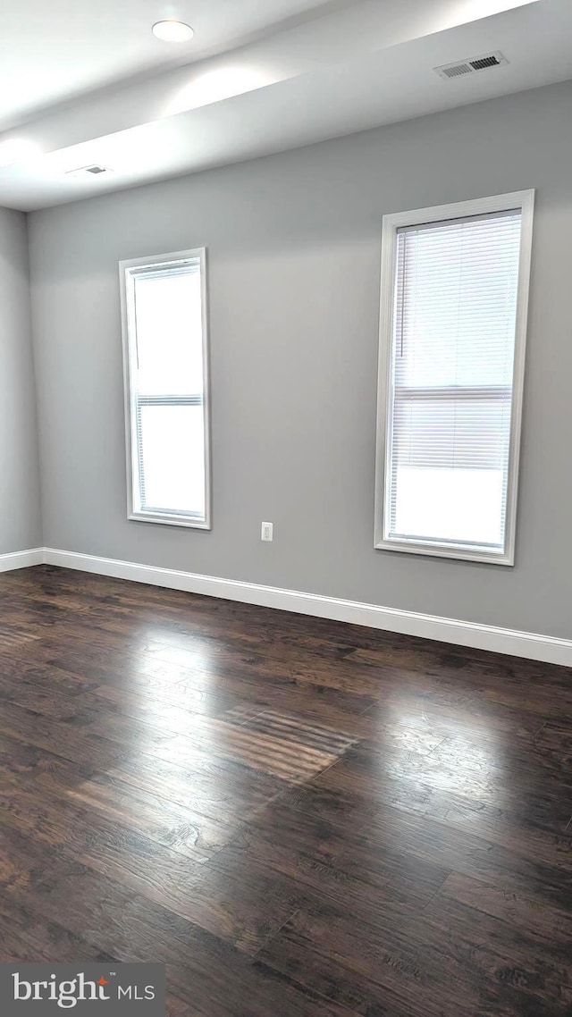 spare room with dark hardwood / wood-style flooring