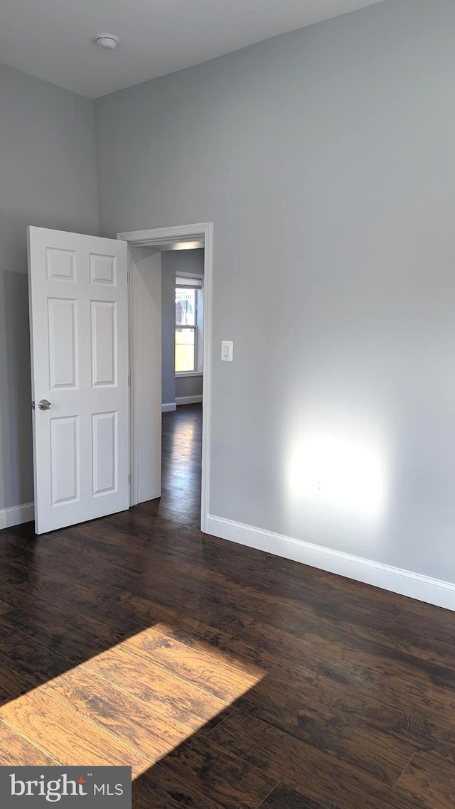 empty room featuring dark hardwood / wood-style floors