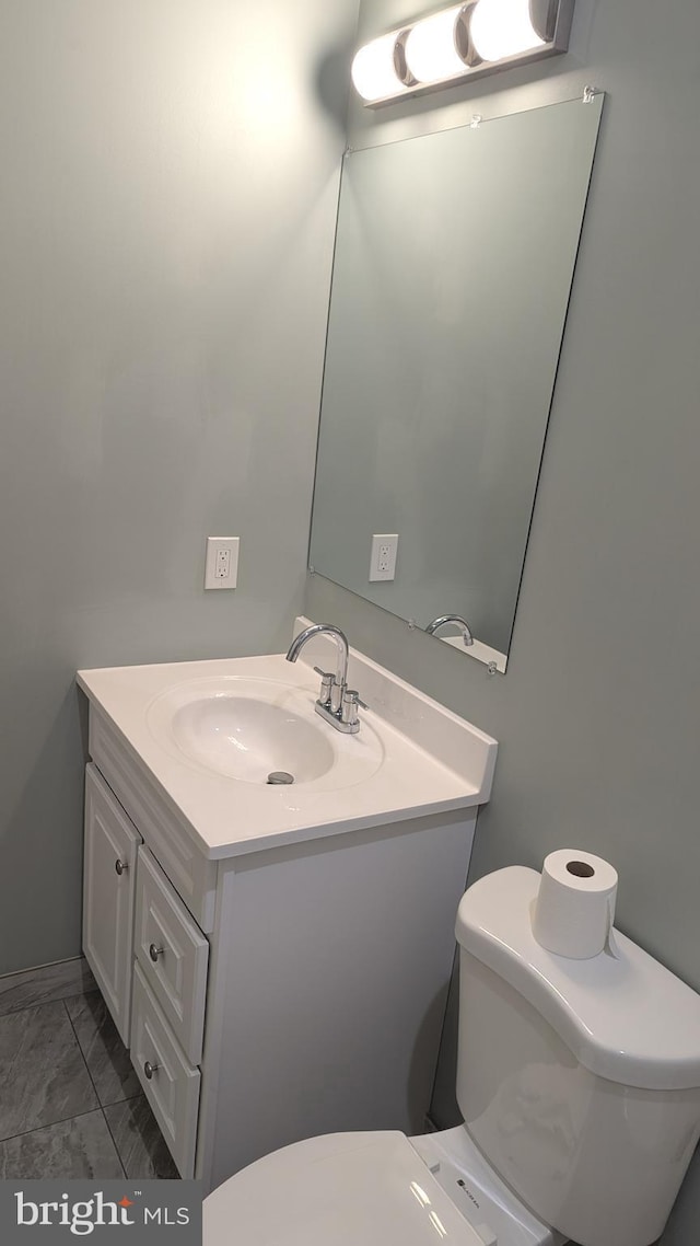 bathroom with toilet and vanity