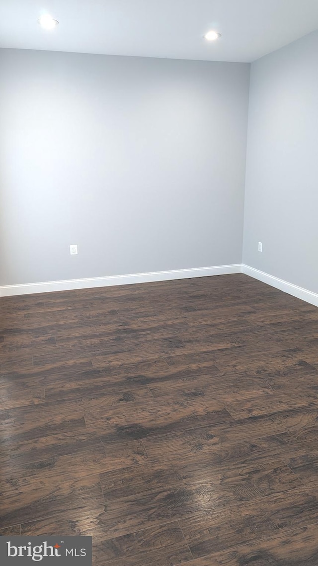 spare room featuring dark wood-type flooring