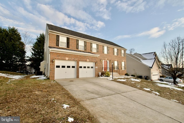 view of front of house featuring a garage and central air condition unit