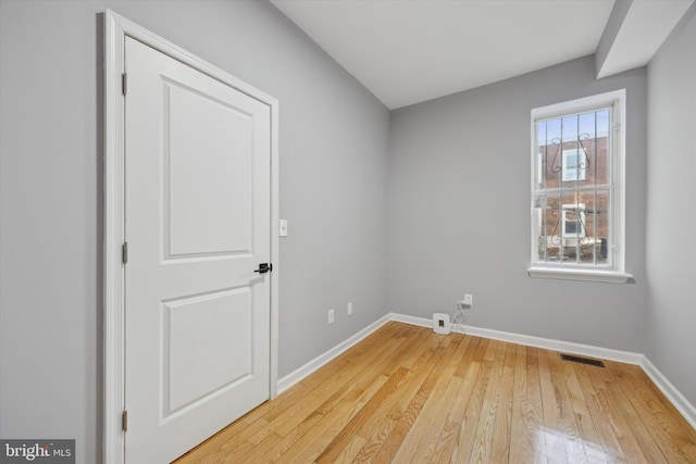 unfurnished room with light wood-type flooring