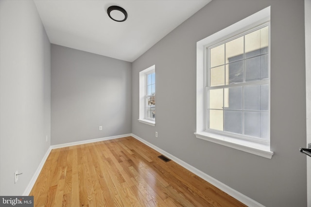 spare room with light hardwood / wood-style flooring