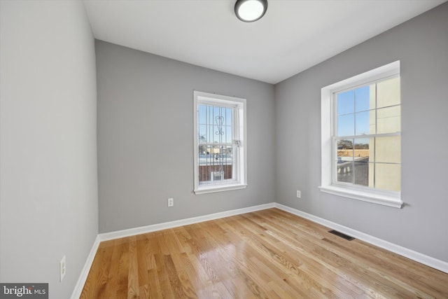 spare room featuring light hardwood / wood-style flooring