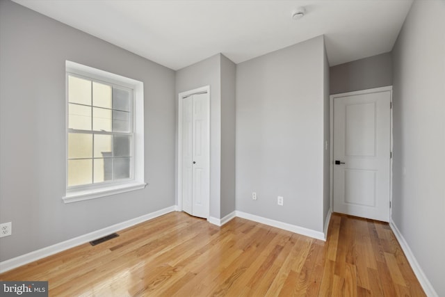 unfurnished bedroom featuring light wood-type flooring