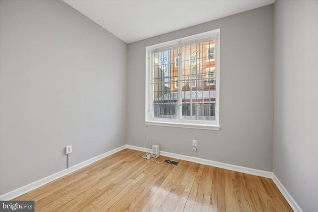 unfurnished room featuring light hardwood / wood-style flooring and a healthy amount of sunlight