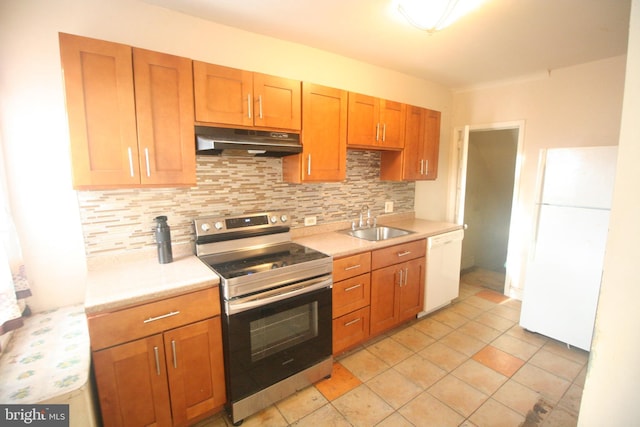 kitchen with light tile patterned floors, white appliances, tasteful backsplash, and sink