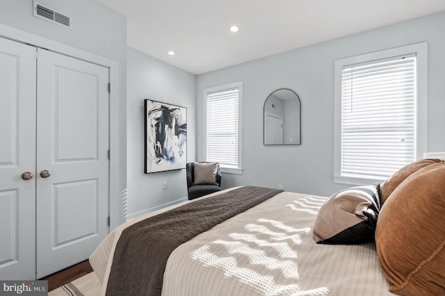 bedroom with hardwood / wood-style flooring and a closet