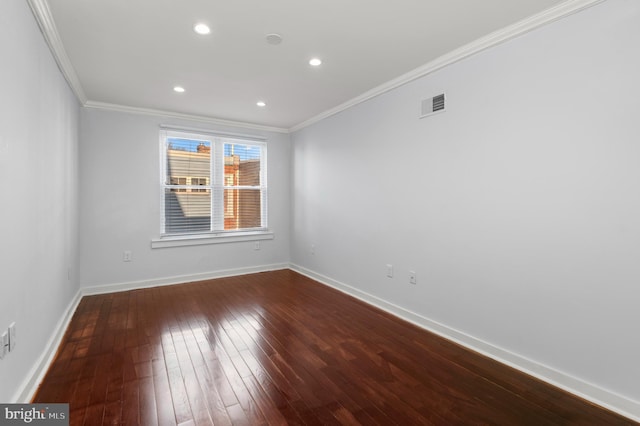 spare room with wood-type flooring and ornamental molding