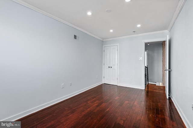 unfurnished bedroom with crown molding and dark wood-type flooring