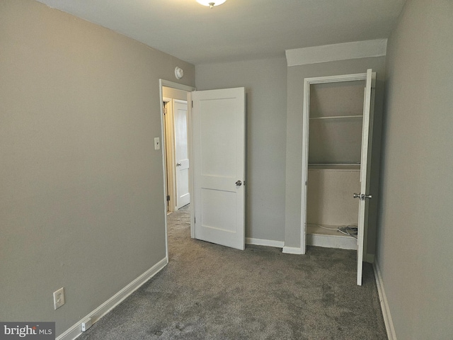 unfurnished bedroom with dark colored carpet