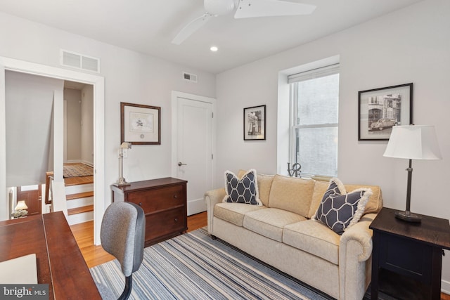 living room with hardwood / wood-style floors and ceiling fan