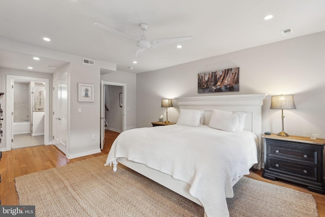 bedroom featuring ensuite bathroom, ceiling fan, and hardwood / wood-style flooring