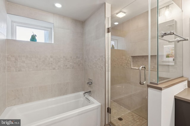 bathroom with separate shower and tub