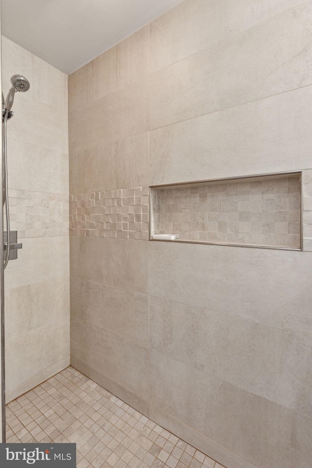 bathroom with a tile shower