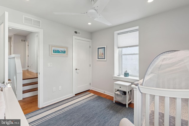 bedroom with a closet, hardwood / wood-style flooring, and ceiling fan