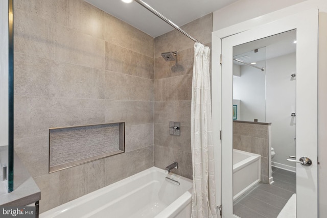 bathroom featuring tile patterned floors, shower / bath combination with curtain, and vanity