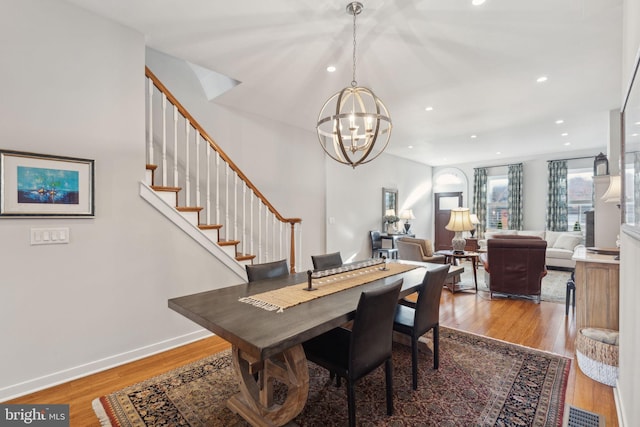 dining area with a notable chandelier and wood-type flooring