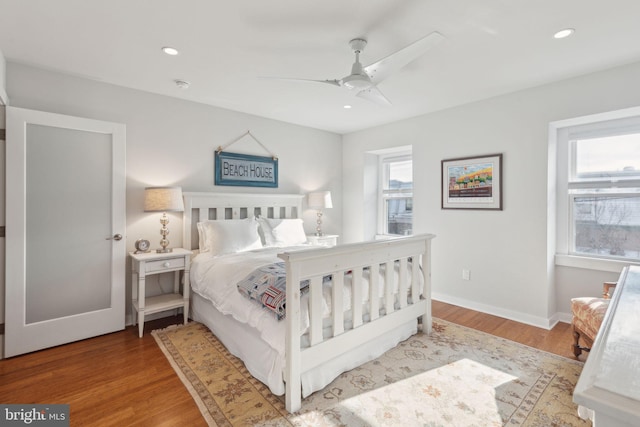 bedroom with hardwood / wood-style flooring and ceiling fan