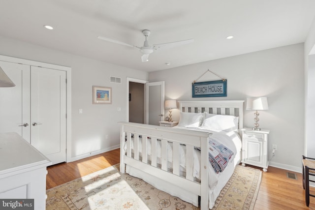 bedroom featuring ceiling fan, a closet, and light wood-type flooring