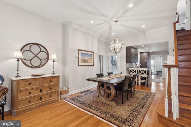 dining area featuring a chandelier and light hardwood / wood-style flooring