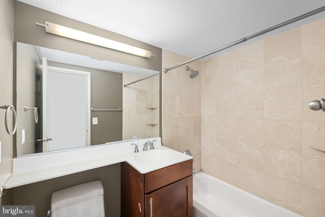 full bathroom with vanity, toilet, and tiled shower / bath