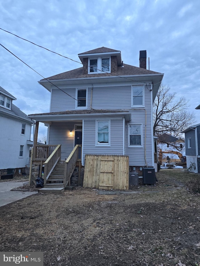 view of front of house with covered porch and central AC unit