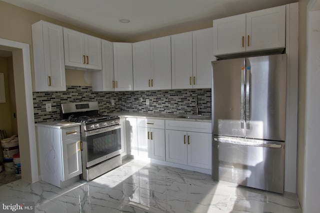 kitchen featuring white cabinets, decorative backsplash, sink, and appliances with stainless steel finishes