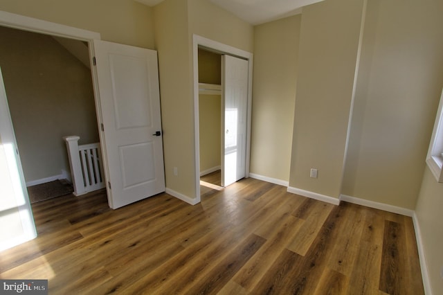 unfurnished bedroom with dark hardwood / wood-style flooring