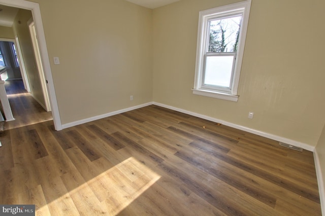 empty room featuring dark hardwood / wood-style flooring