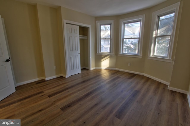 unfurnished bedroom with dark hardwood / wood-style flooring