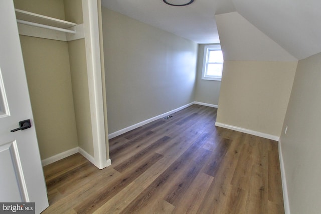 bonus room featuring dark hardwood / wood-style flooring and lofted ceiling