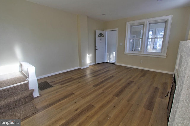 empty room with dark hardwood / wood-style floors