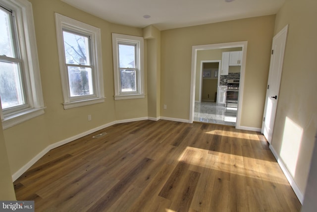 unfurnished room featuring hardwood / wood-style floors