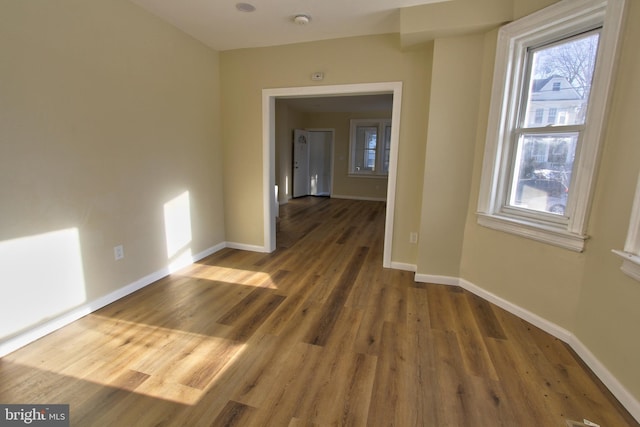 spare room with dark wood-type flooring