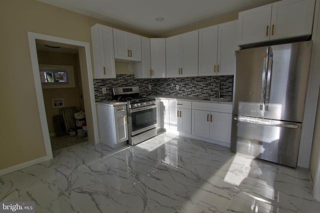 kitchen with white cabinets, decorative backsplash, sink, and appliances with stainless steel finishes